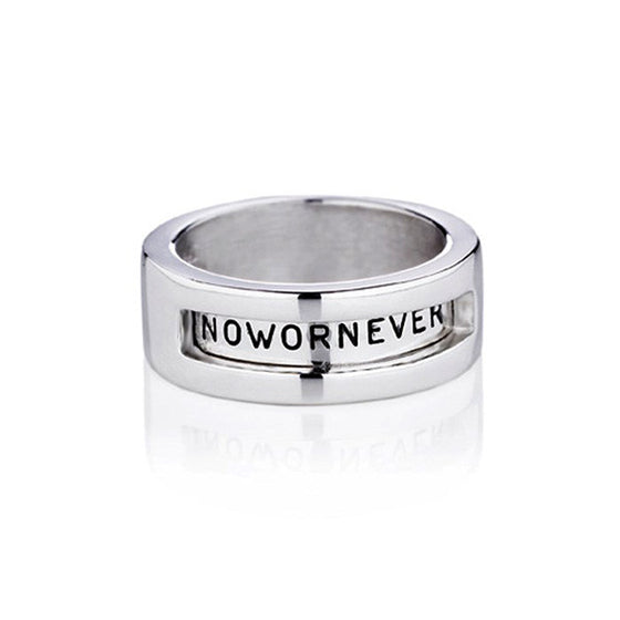 silver band with wording "now or never" by Efva Attling