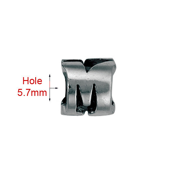 silver bead threading through 5.7mm hole in a letter M