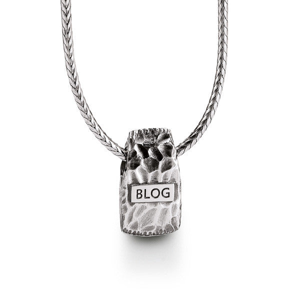 reverse of silver axe pendant showing Blog logo